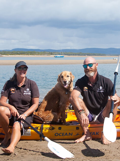 Team photo of the guides from 1770 Liquid Adventures standing on the beach with kayaks in Seventeen Seventy