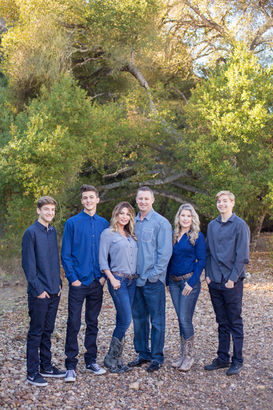 Family of six dressed in blue jeans and blue and grey shirts at Marian Bear Park