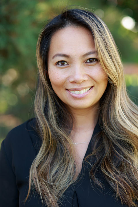 Asian woman black blouse posing for outdoor headshot photo