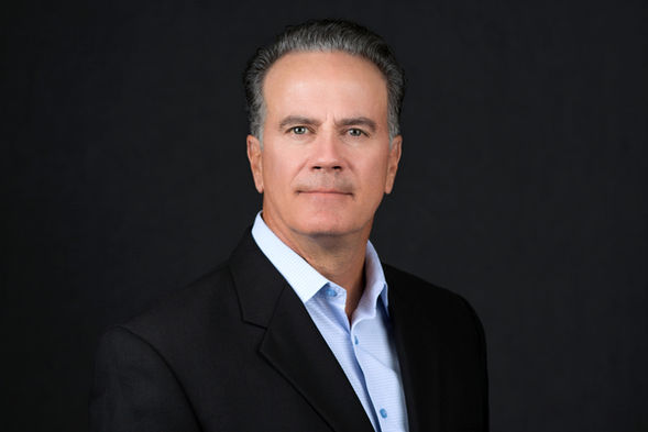 Professional corporate headshot of Walt Edwards, looking confident in a black suit, photographed by San Diego photographer Cary Pennington.