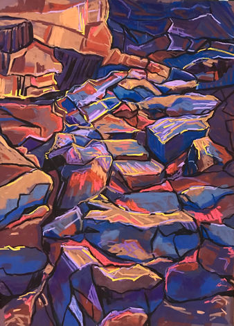 Purple rocks leading to a cave.