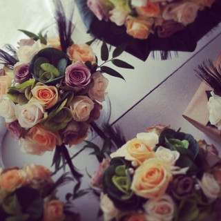 Rose and peacock feather bouquets