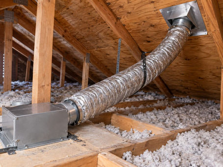 Insulated bathroom exhaust duct connected from a ceiling fan to an exterior roof cap