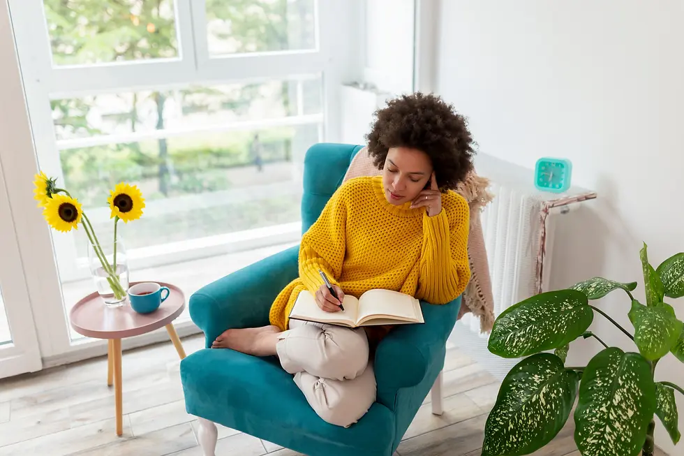 Entrepreneur sitting in a cozy chair, reflecting and journaling, symbolizing the importance of self-awareness in recognizing early signs of burnout such as irritability, fatigue, and loss of motivation. Regular journaling, as taught by Randy Belham, Montreal's best life coach for entrepreneurs, helps leaders process emotions, manage stress, and maintain emotional clarity for better decision-making.