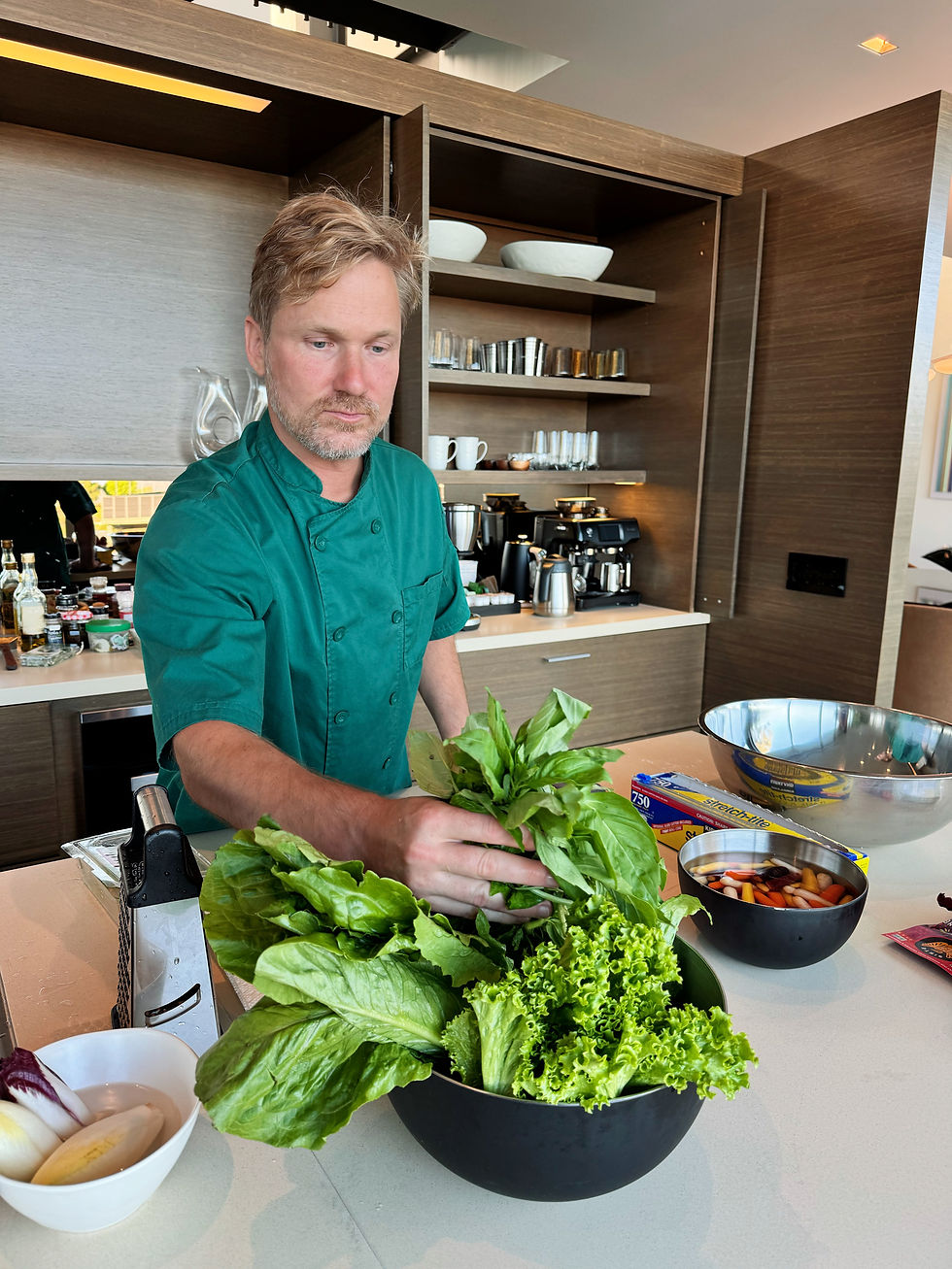 Chef Nathaniel with fresh organic greens and herbs