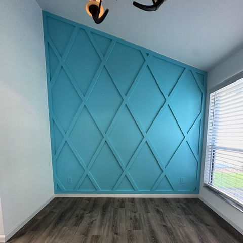 Blue diamond pattern accent wall with geometric trim in a Ponte Vedra FL room, custom-built by AVP Construction JAX.