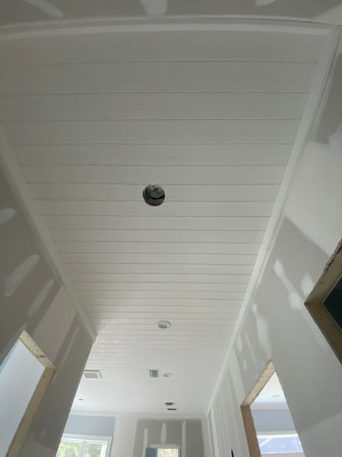 White tongue-and-groove ceiling installation in hallway under construction in Durbin Crossing, St. Johns FL by AVP Construction JAX.