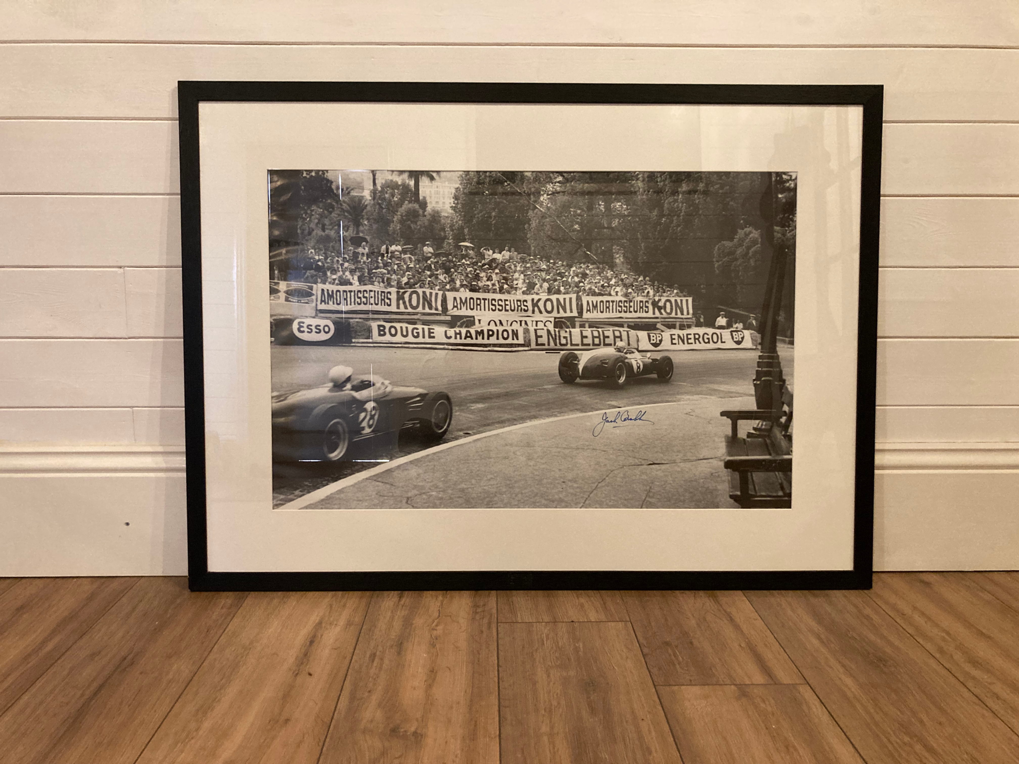 Large Stirling Moss & Jack Brabham framed black & white photo print.