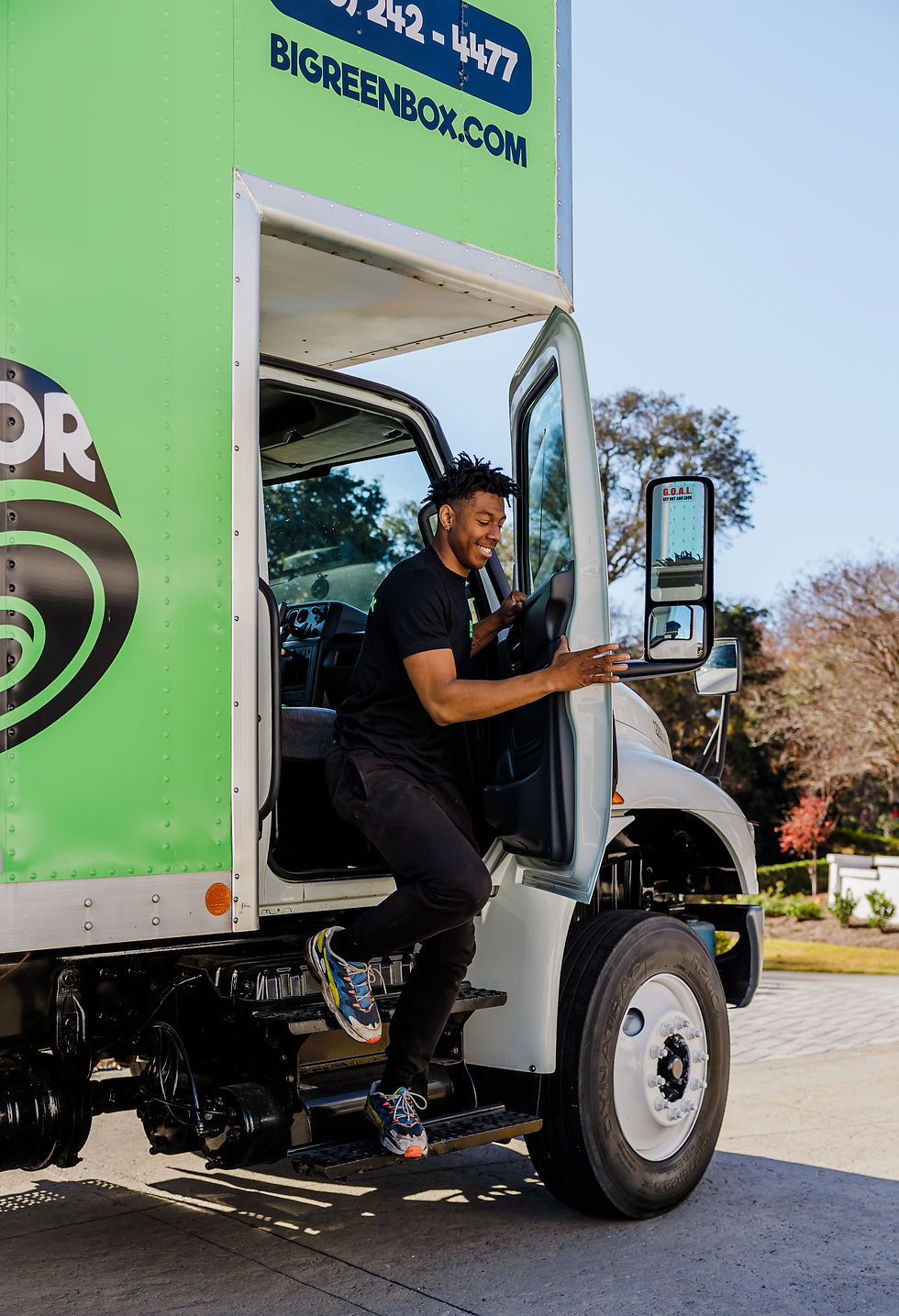 Big Green Box Moving driver stepping out of the truck cab for a Shallotte, NC move