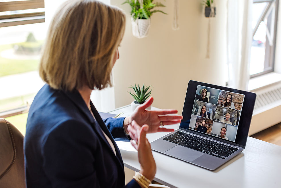 Woman hosting a virtual employee engagement workshop with a team of employees.