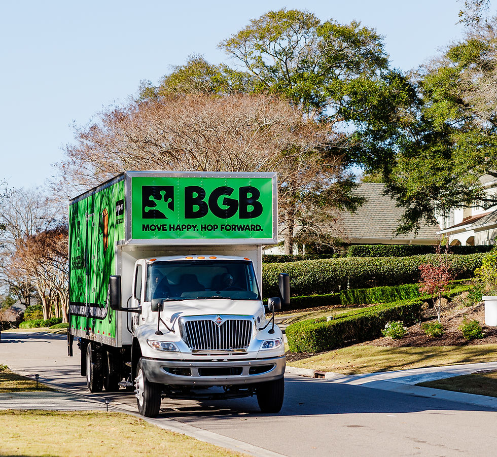 Big Green Box Moving truck loaded outside a home in Ocean Isle Beach, NC