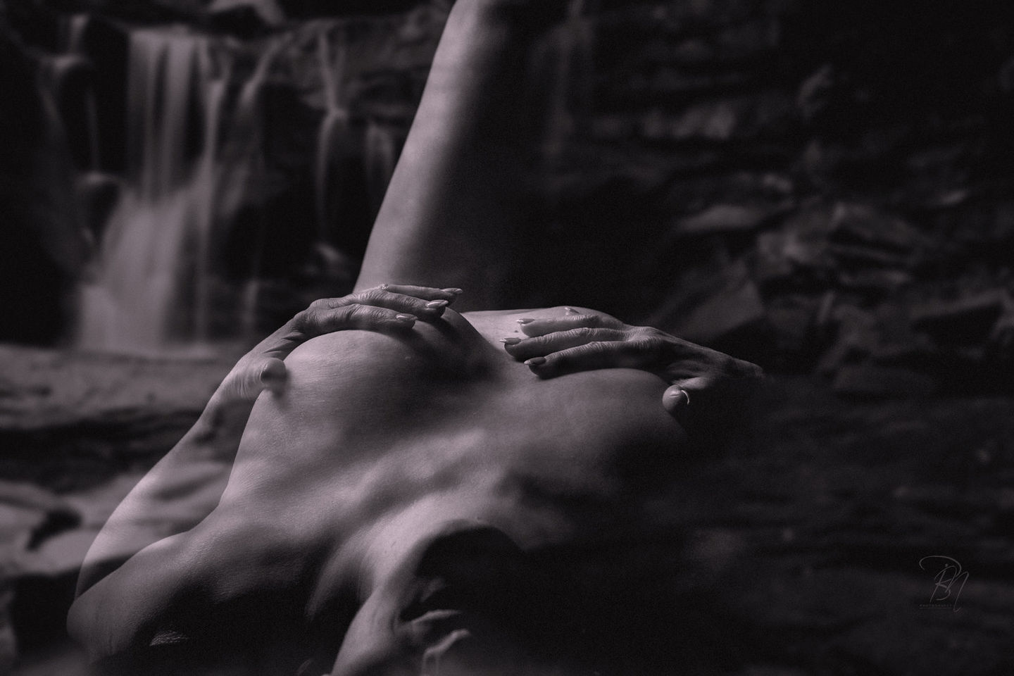 Nude woman with hands on chest and waterfall background, Ébredés - Budapest - 2017