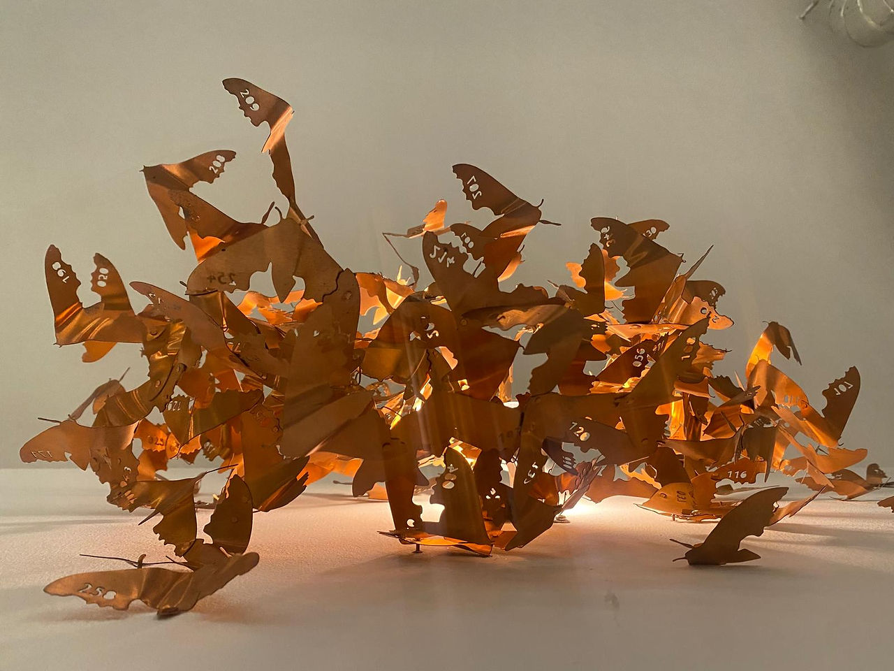 Abstract art of brown leaves, with light. Delicate decorative sculpture.