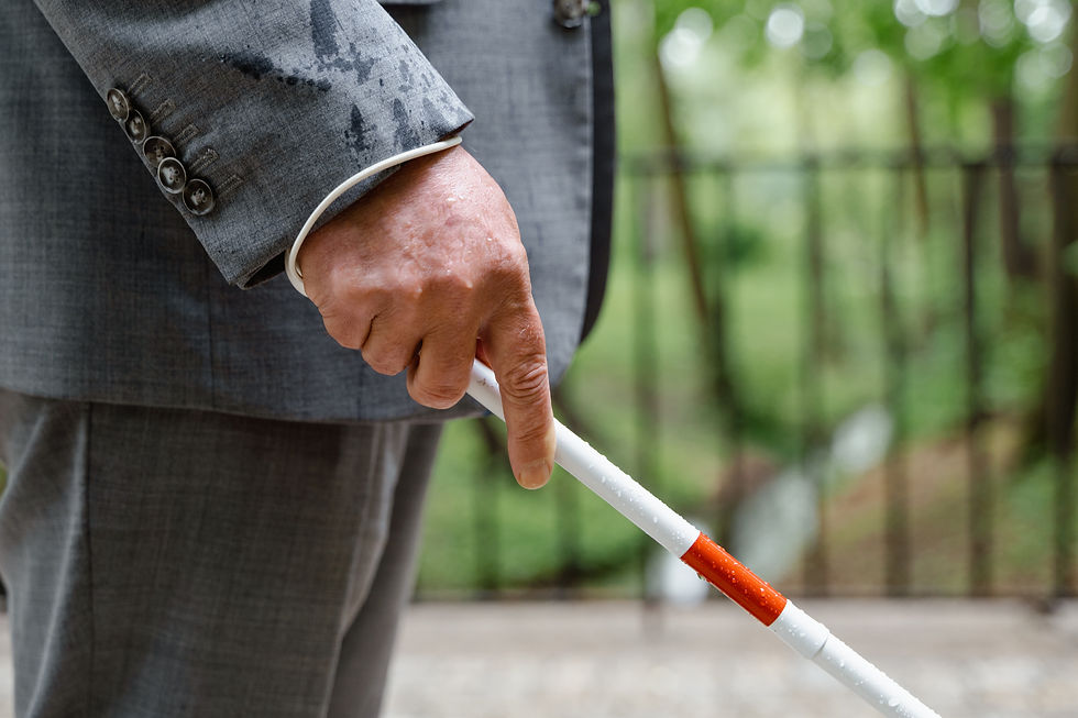 Person in suit using white cane