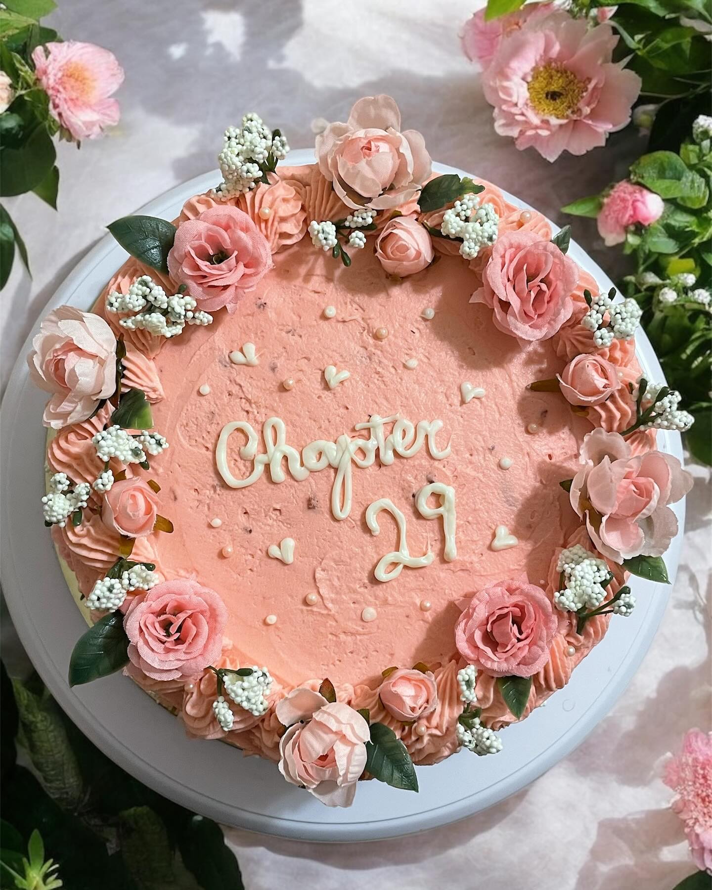 Pink celebration cake with floral piping