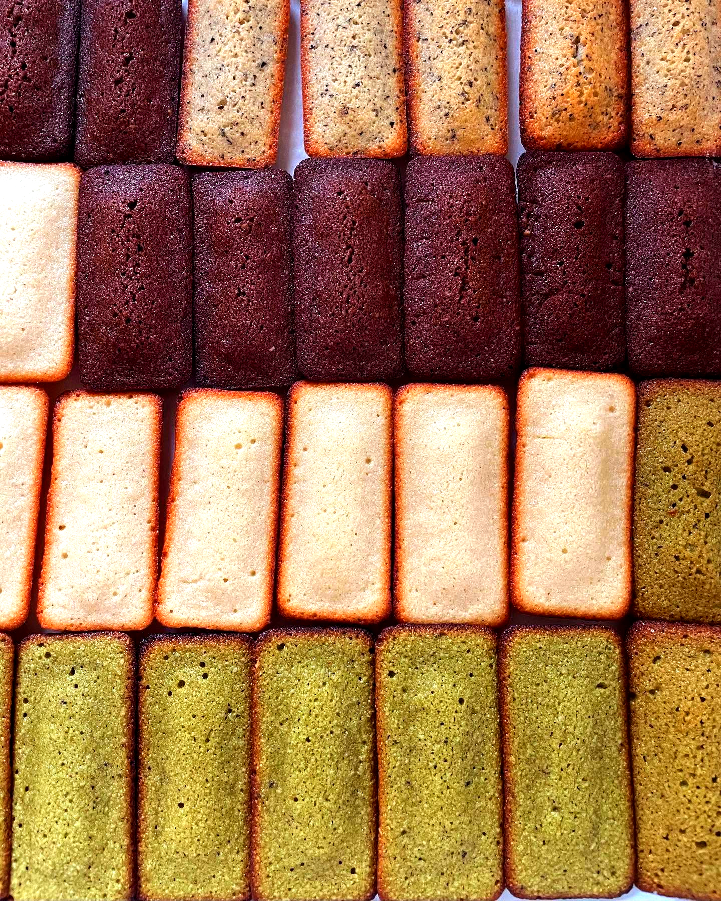 Rows of assorted Kumo Cake Studio financiers