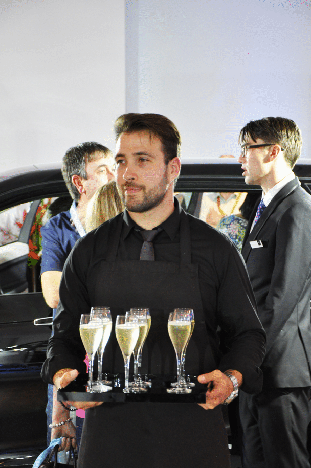 xperienced waiter serving at a formal London event