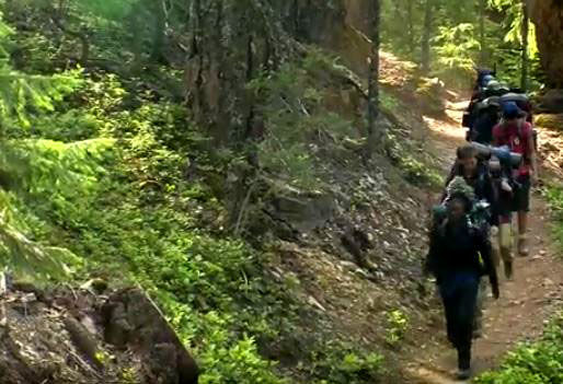 Boys Outdoor Leadership Training group hiking with full packs