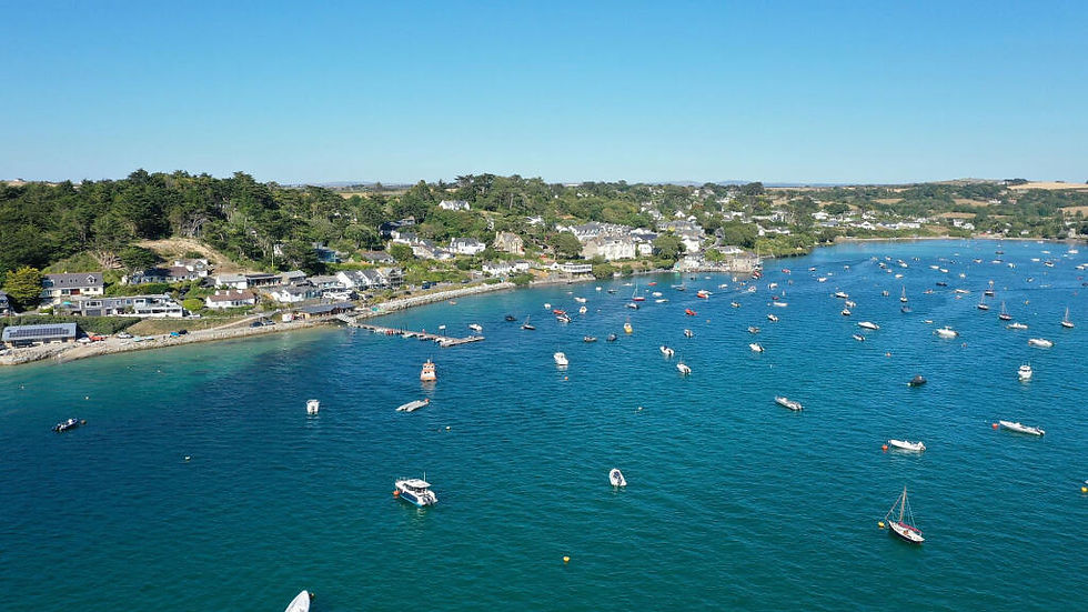 Wide angle view of a sandy beach with calm sea and blue sky