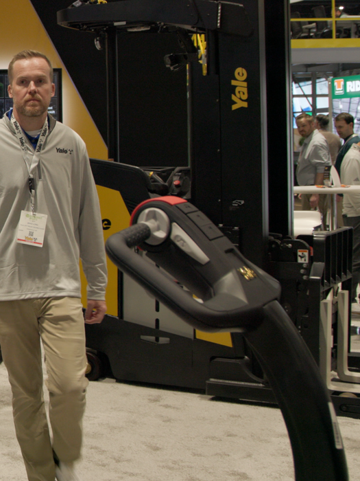 Cameraman filming Brad Long at the Yale booth during ProMat 2025 for the daily recap video series.