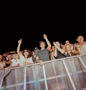 Crowd cheering at Iron Blossom Festival during a live event produced by IMGoing Events, showing fans gathered at the front of