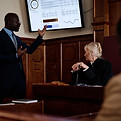 An attorney presenting a PowerPoint in the courtroom. 