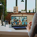 An employee working remotely attending a meeting on Zoom.
