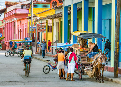 Street photograph of people buying fruit and vegetable from a vendor in a donkey cart with colorful building in Baracoa, Cuba, Travel Photography, Photo,