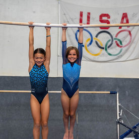 gymnasts hanging from a bar