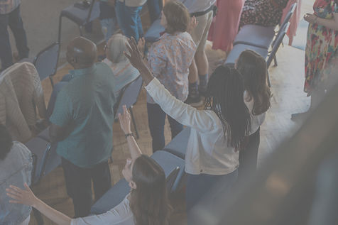 Diverse congregation joining hands in prayer at Centre Church