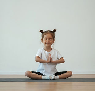 cute-little-girl-is-sitting-yoga-mat-doing-exercises.jpg