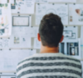 Designer looking at wall of projects