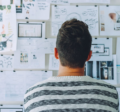 Designer looking at wall of projects