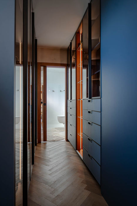 custom built in wardrobe coridor with blue leather, tinted glass finish and custom lighting