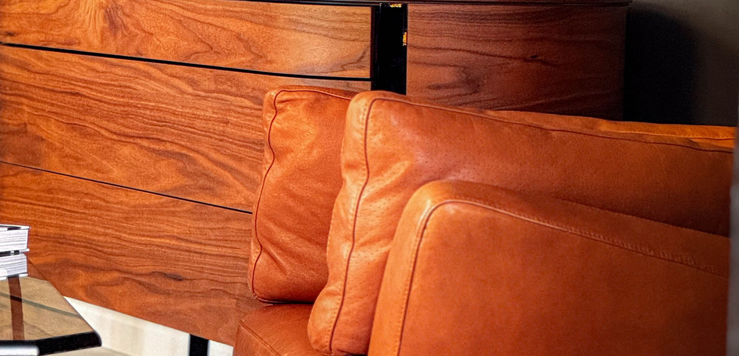 close-up of high end leather and wood furniture in camel and caramel tones