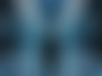 A man in a professional suit standing in a futuristic, glowing blue data center representing the intersection of human identity and digital infrastructure.