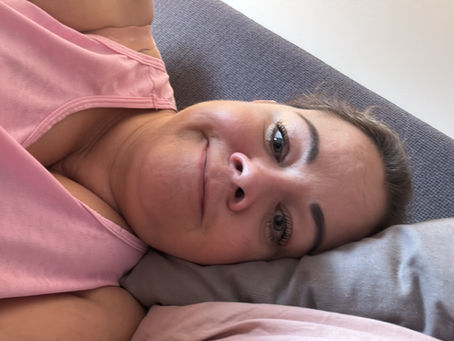 Leanne lying on her bed looking glum