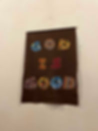 Banner with diverse patterns that says "God Is Good".