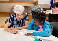 Adult helping child with school work