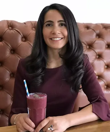 A naturopath drinking a smoothie