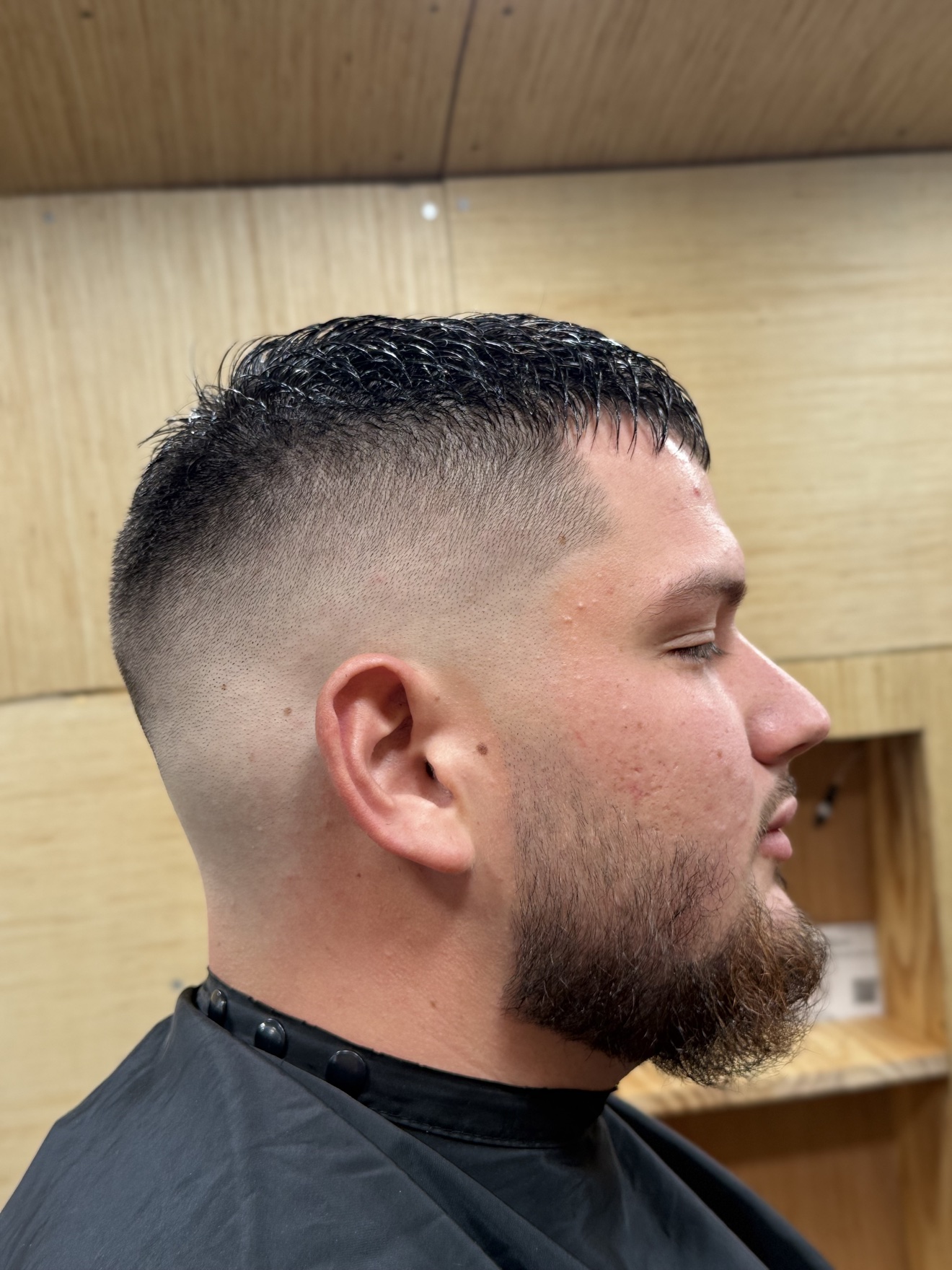 High skin fade with shaped beard, right side view