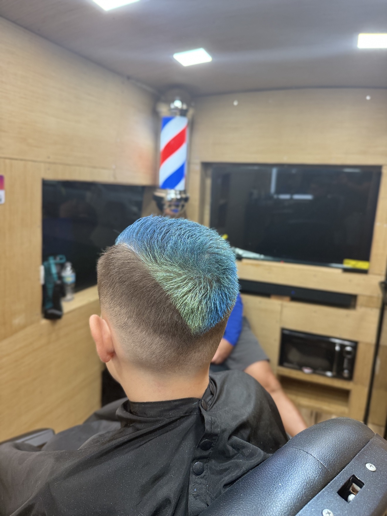 Kids fade with blue-green colored top, back view