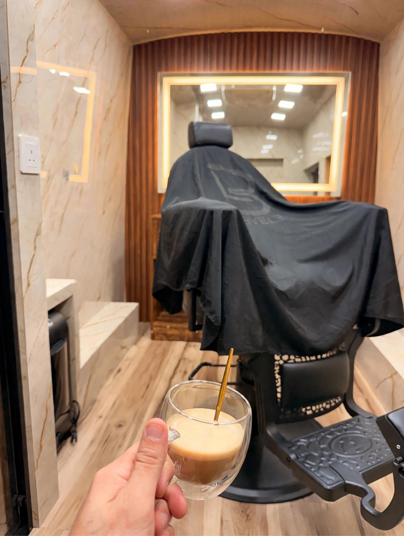 Interior of The Calling mobile barbershop with professional chair and illuminated mirror