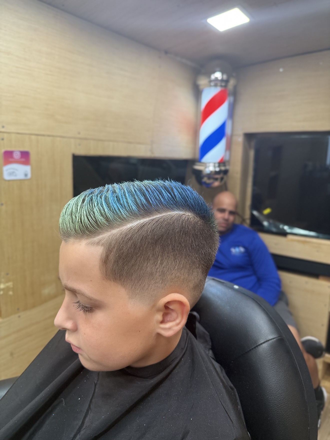 Kids fade with blue-green colored top, side view
