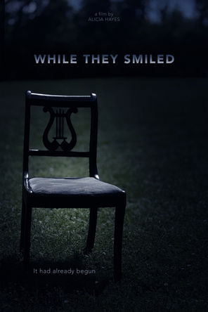 Empty chair in moonlit field from WHILE THEY SMILED
Official poster for WHILE THEY SMILED by Alicia Hayes
Atmospheric short documentary poster
Psychological documentary film imagery
Alicia Hayes documentary film poster