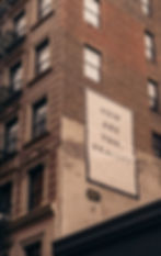 "How are you, really?" painted on the side of a brick building, representing self-reflection and mental health awareness during career transitions.