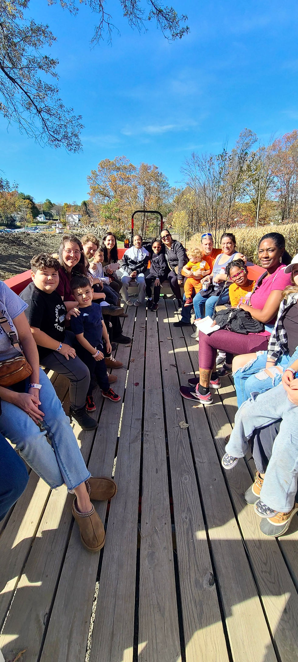 Group of people smiling on a hayride