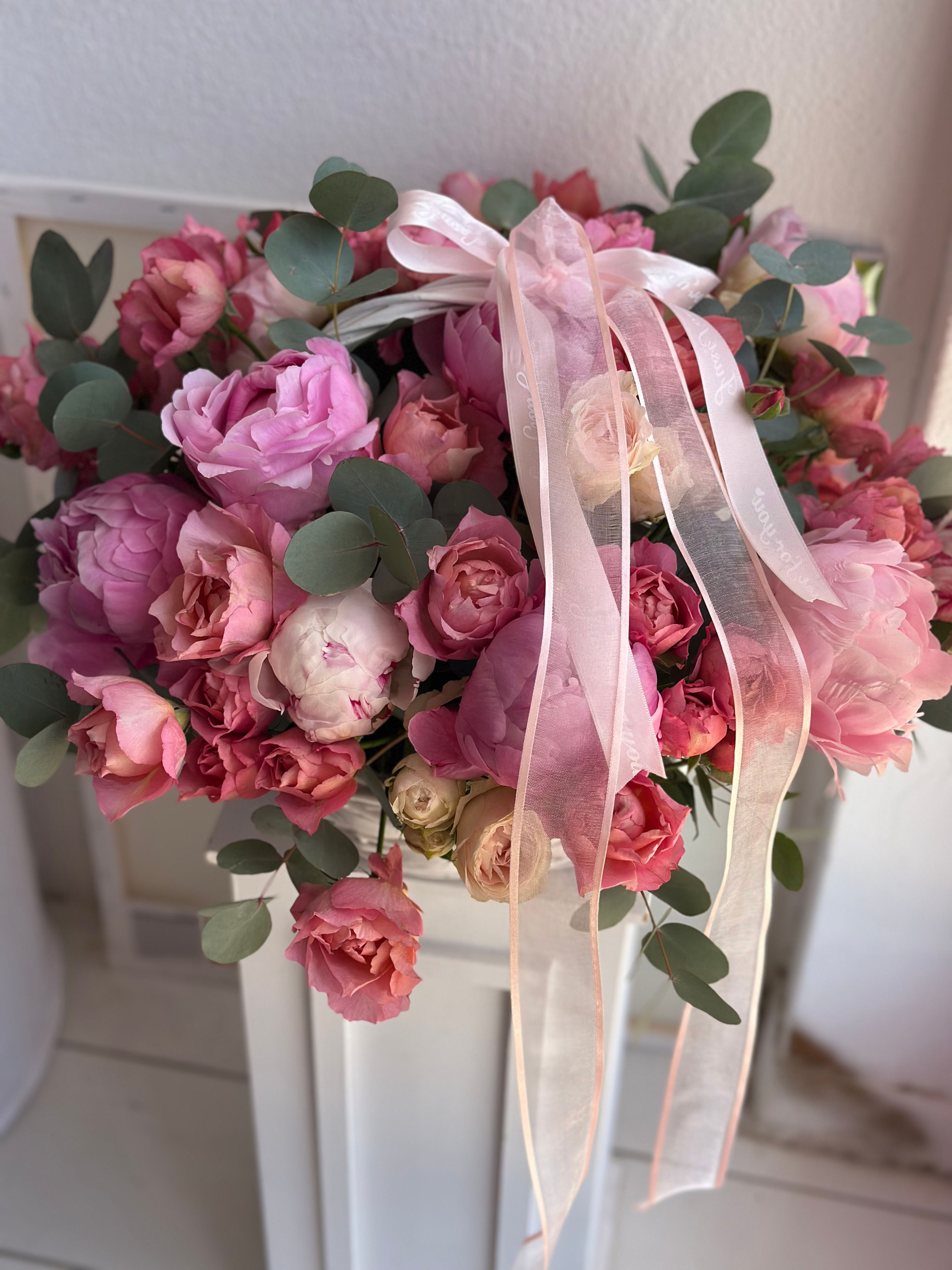 Basket with peonies and spray roses 