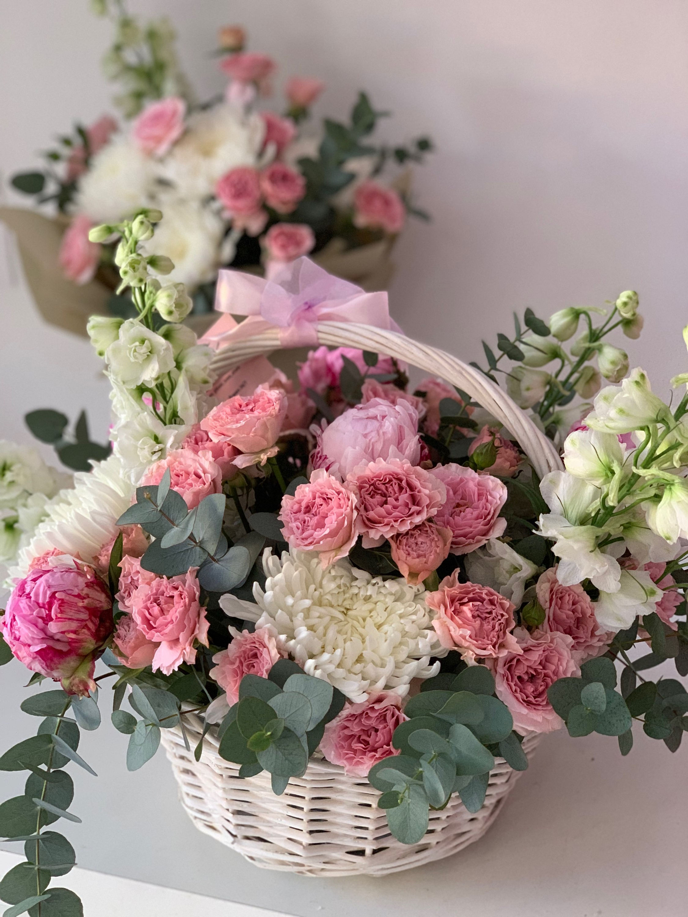 Wicker basket with peonies and bush roses