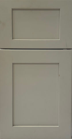 Marie paint-grade cabinet door with stone finish and reverse raised center panel.